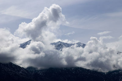 Clouds against mountain range