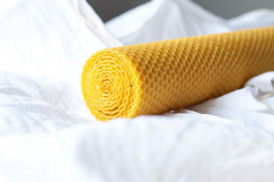 Close-up of yellow toy on bed