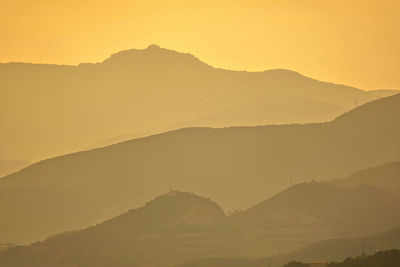 Scenic view of mountains against sky during sunset