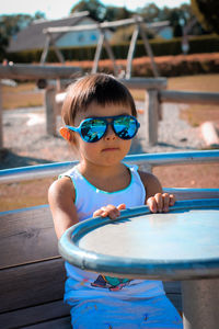 Portrait of girl in sunglasses siting outdoors