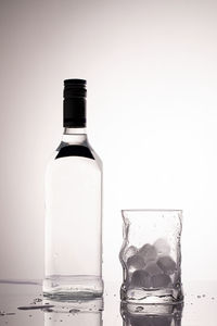 Close-up of glass bottle against white background