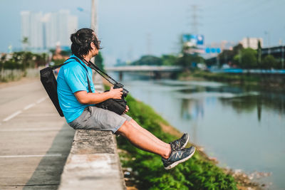 Man photographing with mobile phone in lake