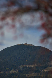 Low angle view of buildings on mountain against sky