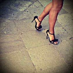 Low section of woman standing on tiled floor