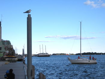 Boats in sea against clear sky