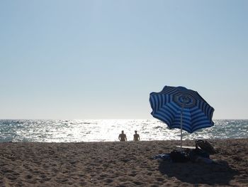 Scenic view of beach against clear sky