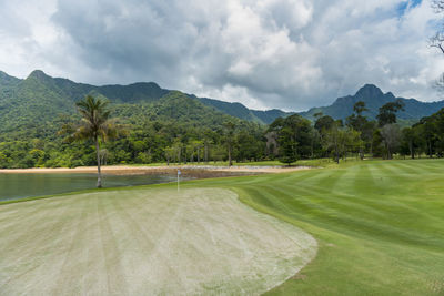 Scenic view of golf course against sky