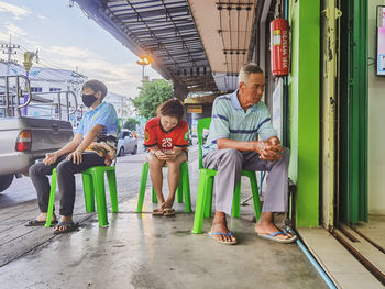 Rear view of people sitting on seat