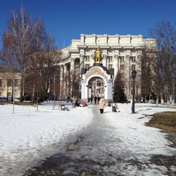 Buildings in city against clear sky during winter