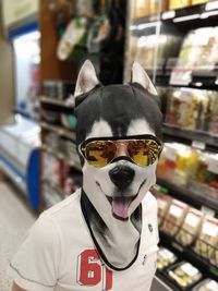 Portrait of man wearing sunglasses standing in store