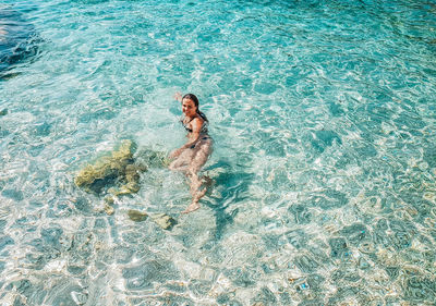 High angle view of woman swimming in sea