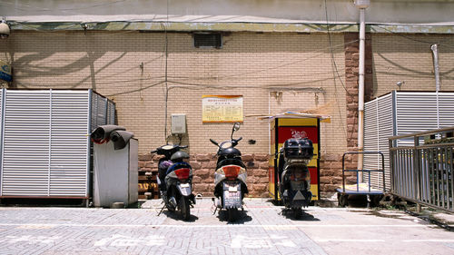 Rear view of people standing on street against building