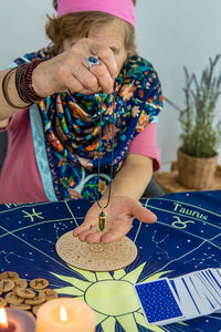 Midsection of woman painting on table