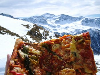 Close-up of pizza against mountains