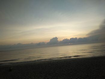 Scenic view of beach against sky during sunset