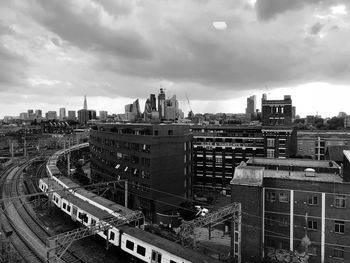 High angle view of railroad tracks amidst buildings in city