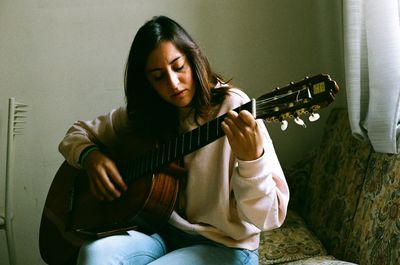 Young woman playing guitar