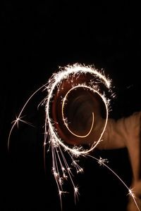 Low angle view of illuminated fireworks against sky at night