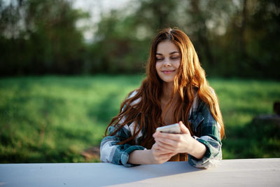 Young woman sitting on field