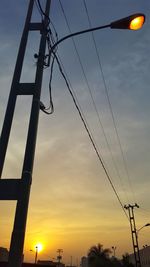 Low angle view of street light against sky at sunset