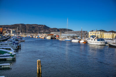 Boats moored at harbor