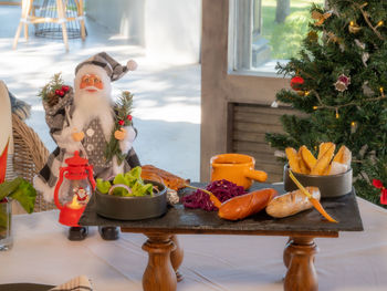 Portrait of woman holding food on table
