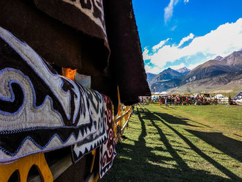 Graffiti on wall by mountain against sky
