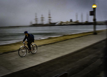 Man riding bicycle on road