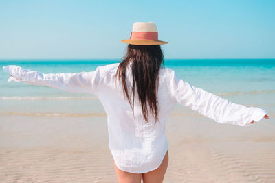 Rear view of woman standing on beach