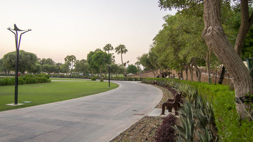 Footpath in park against sky