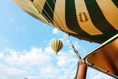 Low angle view of balloons flying against sky