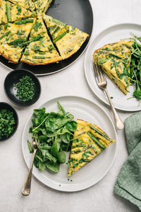 Healthy asparagus frittata meal with arugula salad