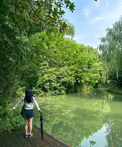 Rear view of woman walking on footpath