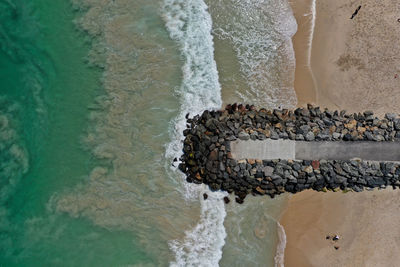 High angle view of groyne on beach