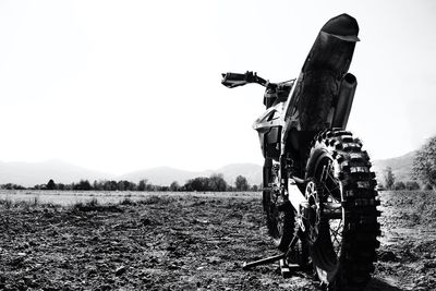 Motocross on field against clear sky