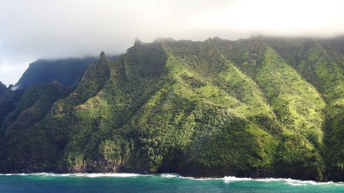 Scenic view of sea and mountains against sky