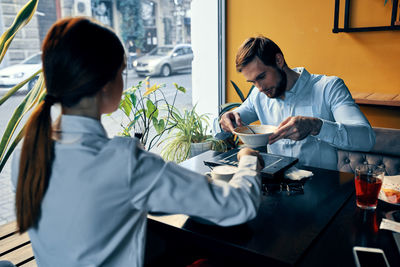 Young couple sitting on table at restaurant