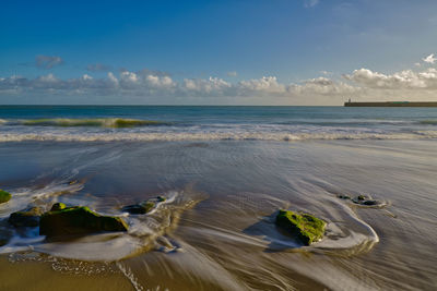Long exposure of retreating tide looking towards folkestone harbour arm