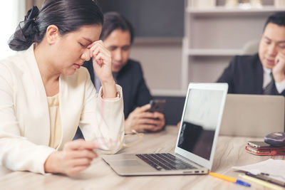 Young woman using laptop at office