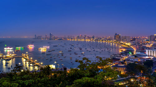 High angle view of city lit up at night