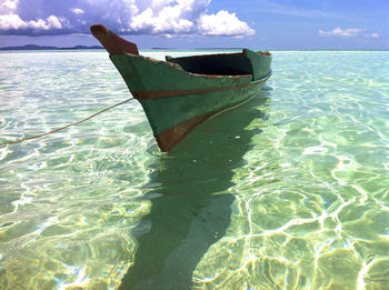 Boat moored on sea against sky