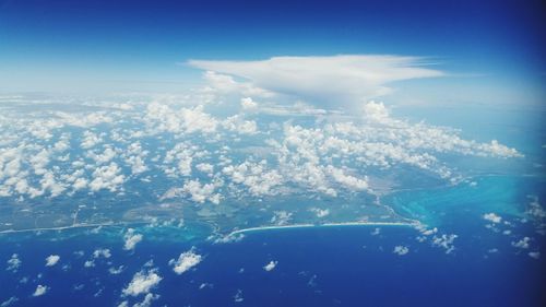 Aerial view of sea against blue sky