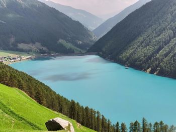 Scenic view of lake amidst mountains against sky