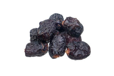 Close-up of black fruits against white background