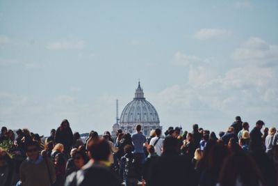 Tourist at st peters basilica against sky