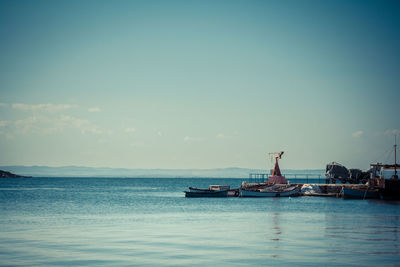 Boat sailing in sea against sky