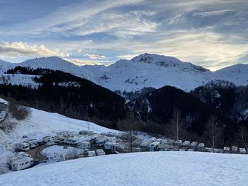 Scenic view of snow covered mountains against sky