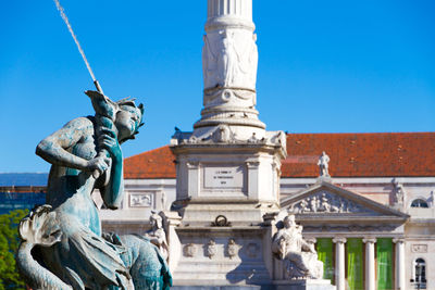 Statue against blue sky