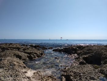 Scenic view of sea against clear blue sky