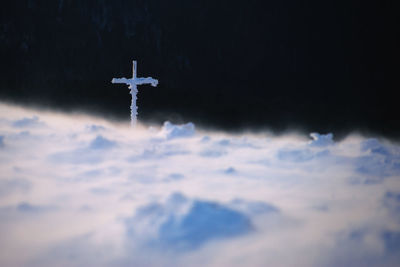 Low angle view of cross against sky